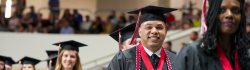 Smiling Student walks in the Spring Commencement Ceremony at NWFSC